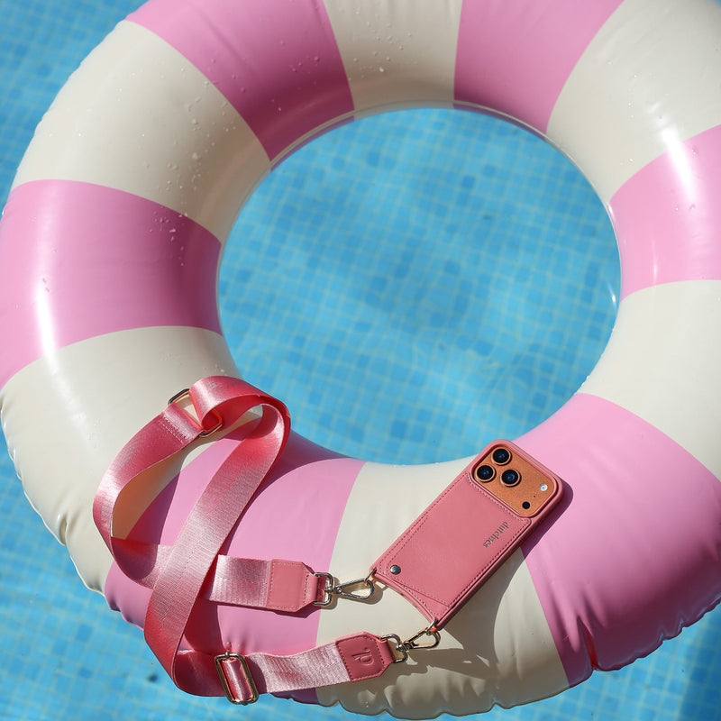 Phone Strap | Basic | Pink elegantly paired with a pink and white lifebuoy in a sunny pool setting.