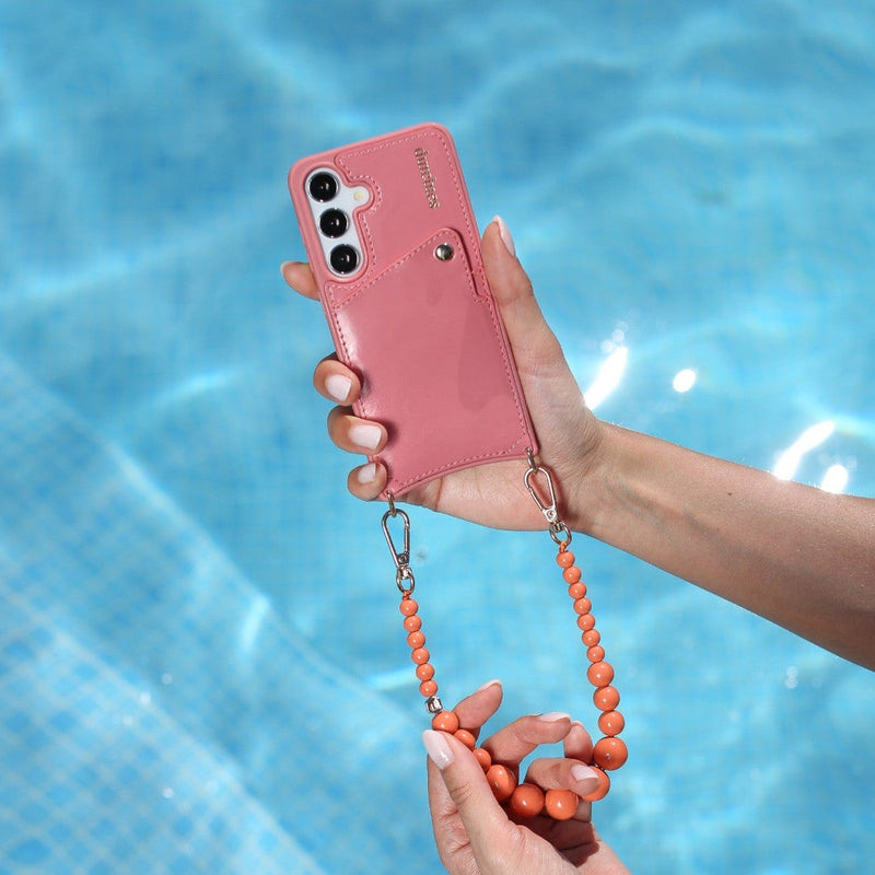 Phone Charm | Beaded | Freya attached to a pink phone held above a sparkling pool.
