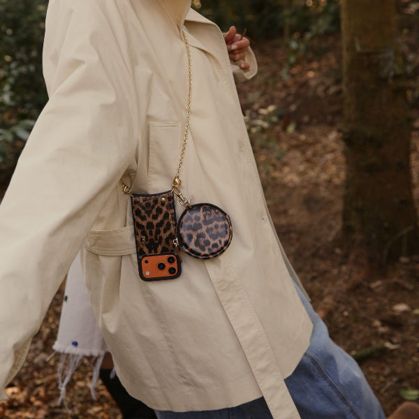 Spanish Chain Set | iPhone | Leopard featured with stylish phone accessories in a forest setting.