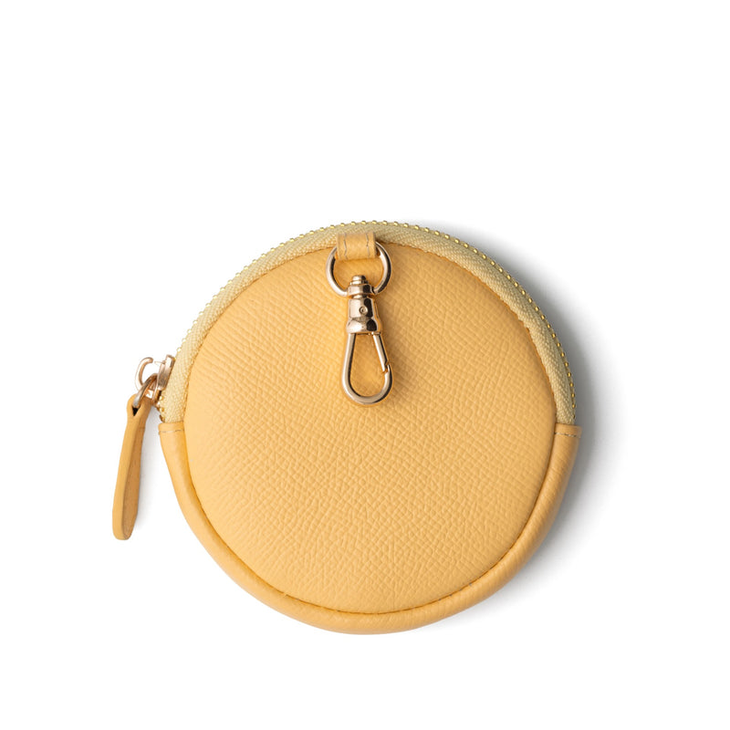 Mini Phone Bag Emma | Yellow - a round yellow leather pouch for storing essentials on the go.