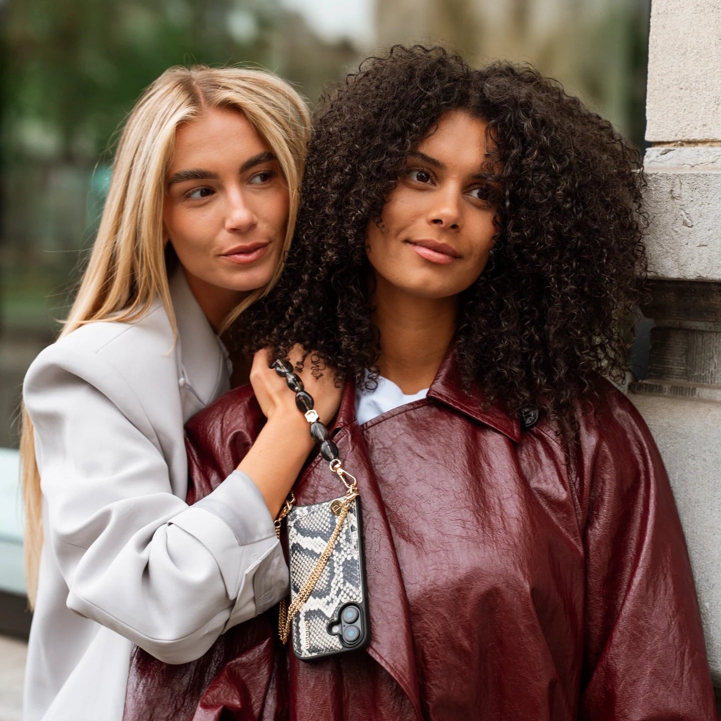 Samsung Case | Snake showcased by two stylish women in urban setting, highlighting its chic snake print design.