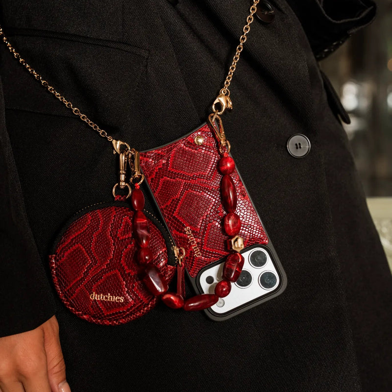 Phone Charm | Beaded | Stevie showcased in red, stylishly accessorized with matching phone case and pouch.