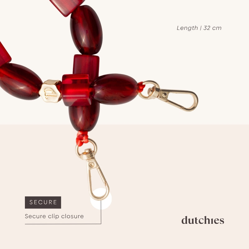 Phone Charm | Beaded | Franky featuring a secure clip closure and vibrant red beads, length 32 cm.