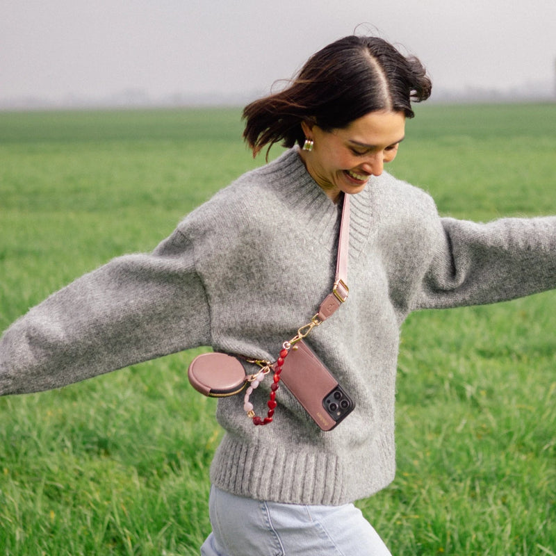 Woman enjoying the outdoors wearing an iPhone Case | Mauve, showcasing its stylish design and functionality.