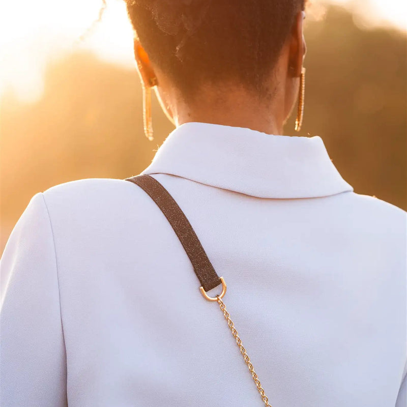 Spanish chain set | Samsung | Denim Glitter stylishly shown on a model's coat with a gold chain strap.