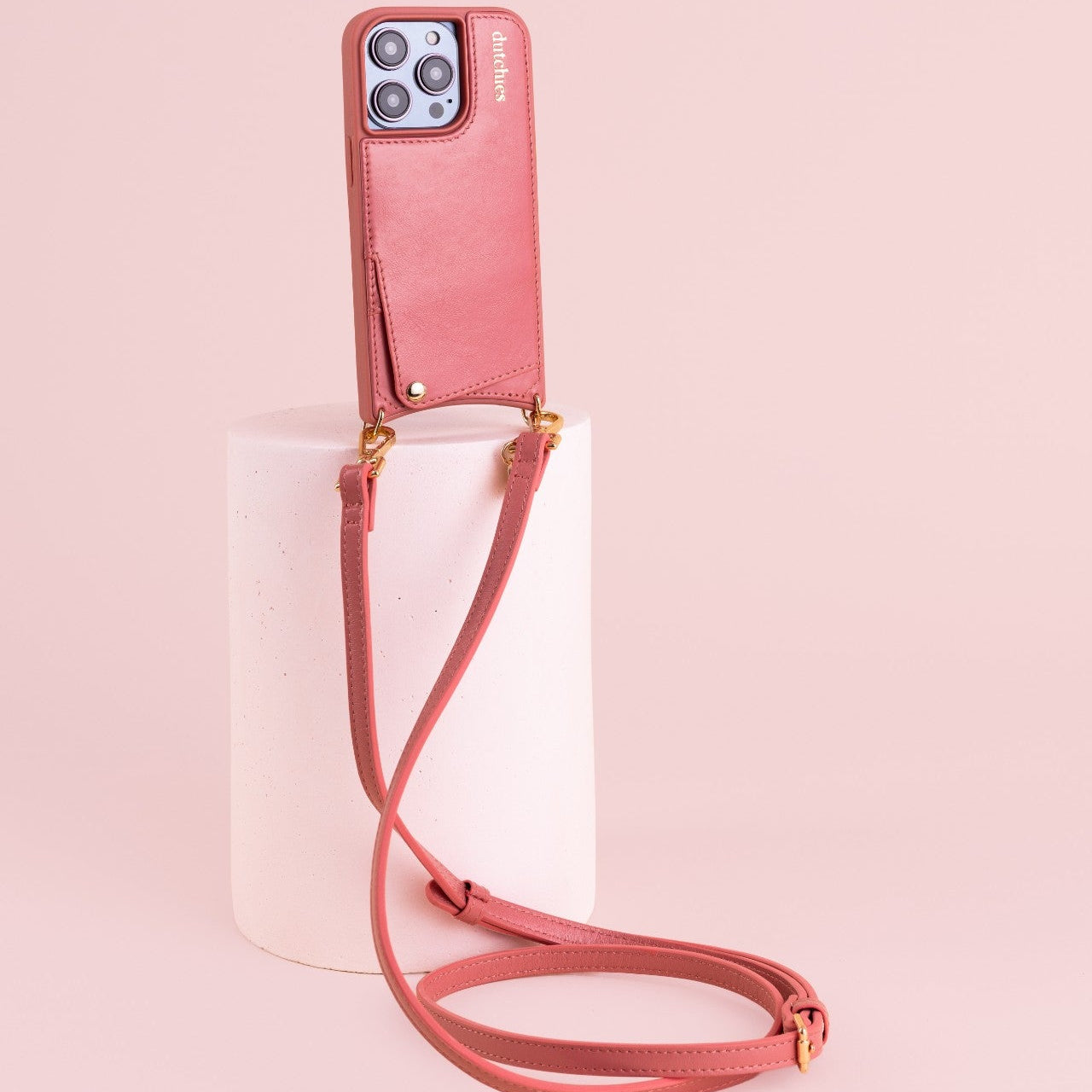 Phone strap | Slimline | Pink attached to a stand, showcasing its trendy design and practical use for busy lifestyles.
