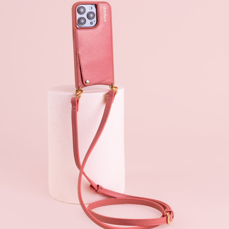 Phone strap | Slimline | Pink attached to a stand, showcasing its trendy design and practical use for busy lifestyles.