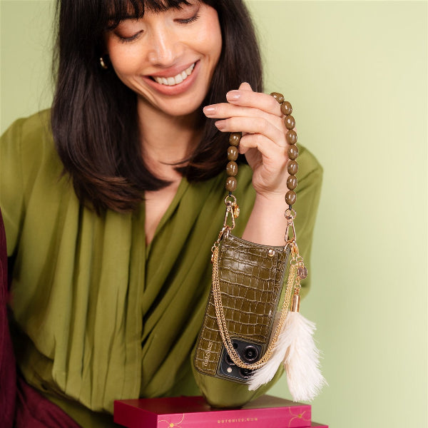 Phone Charm | Beaded | Arte worn by a smiling woman, showcasing a stylish beaded green mobile phone charm.