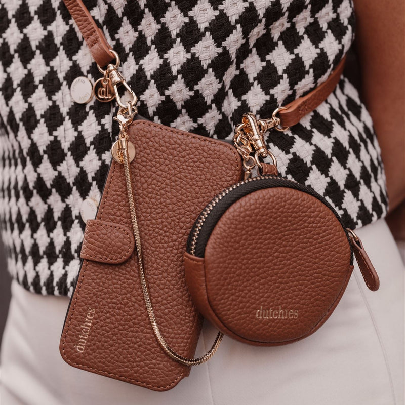 Samsung Wallet Case | Brown against a stylish outfit, showcasing premium leather with gold accents.