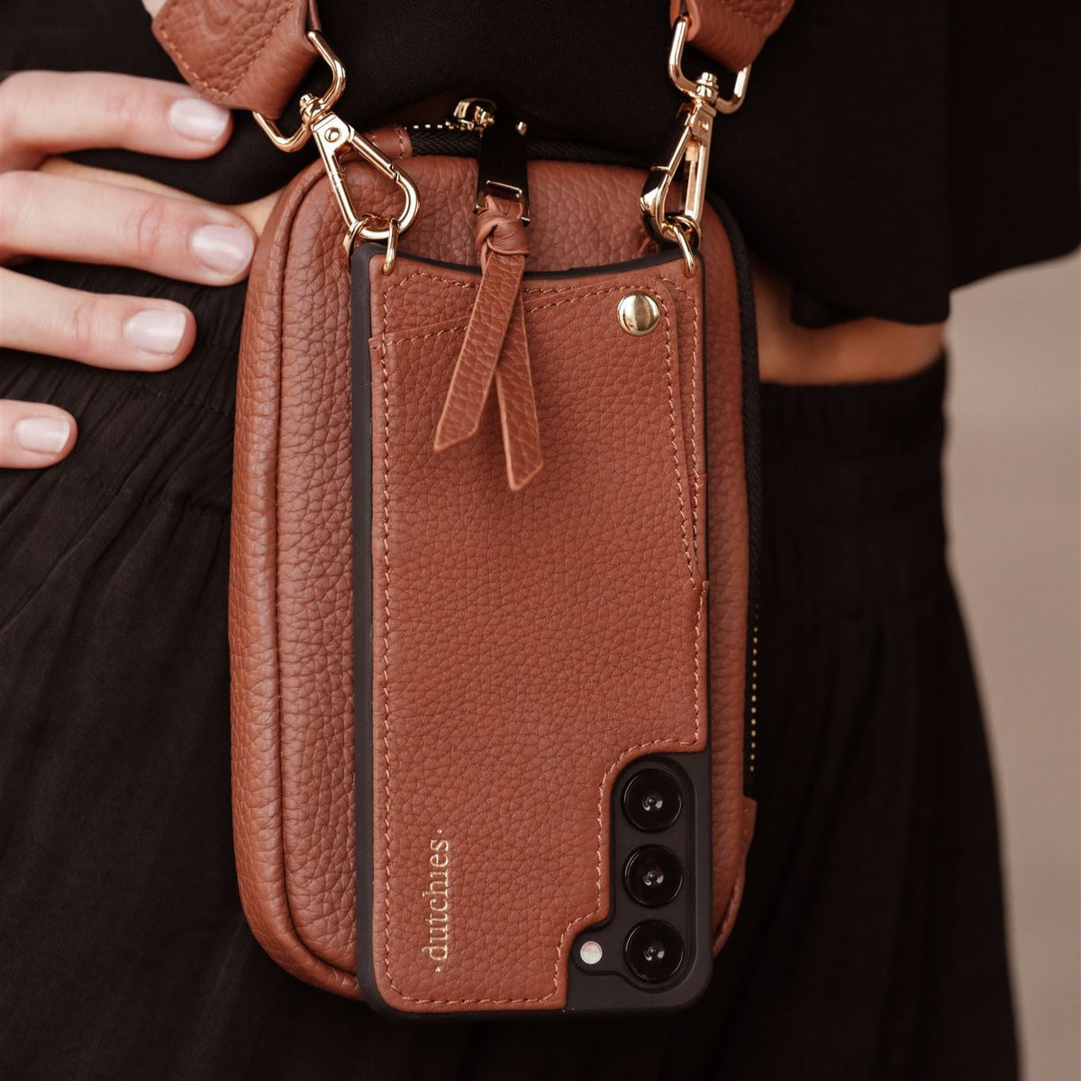 Close-up of the Phone Bag ROSE | Brown, a stylish handmade leather phone pouch with a slim design.