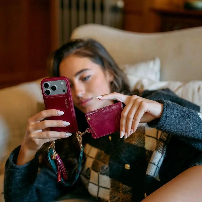 Person using a MagSafe Wallet | Raspberry Red attached to a smartphone, showcasing style and functionality.