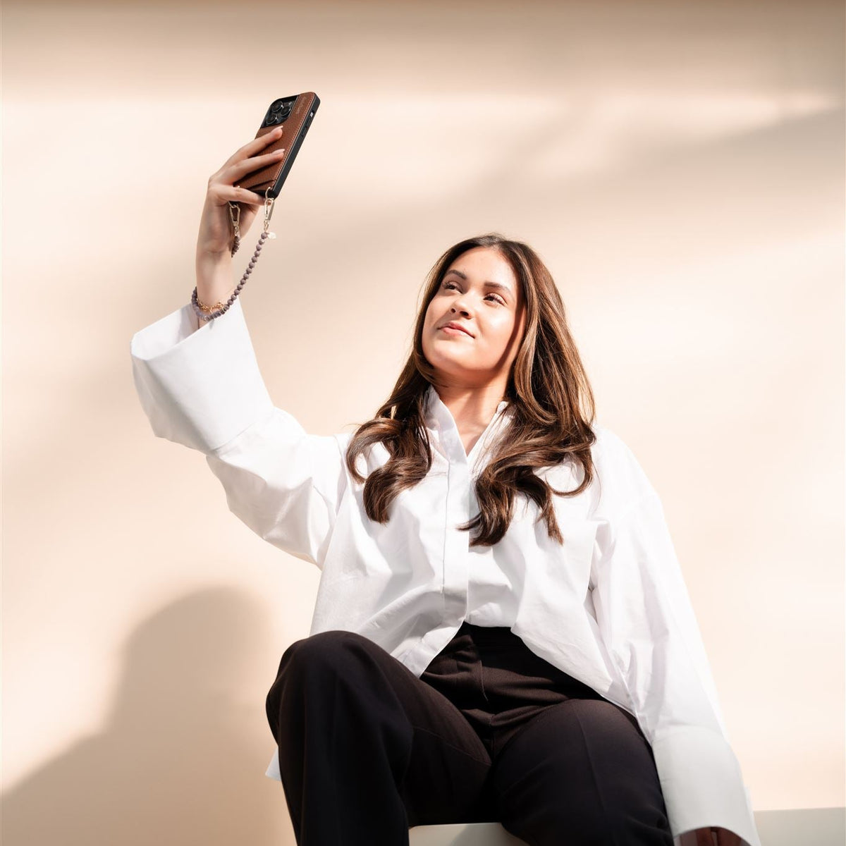 Handyanhänger | Perlen | Aletta wird von einer Frau gezeigt, die ein Selfie macht.