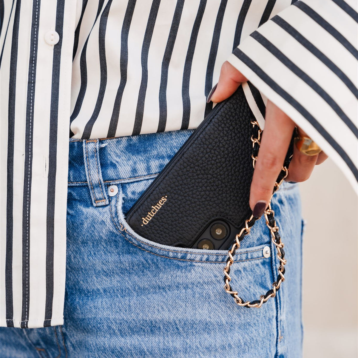 Mobilvedhæng | Italian | Black mobilcover med guldvedhæng i en stilfuld lomme i outfit.