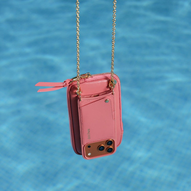 Phone Bag Rose | Pink hanging in water with stylish gold chain, showcasing its sleek design and versatility.