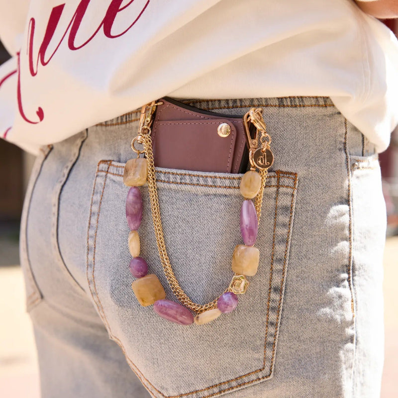 Charm Set | iPhone | Mauve | Annie showcased with a stylish chain and phone case in a casual outfit.