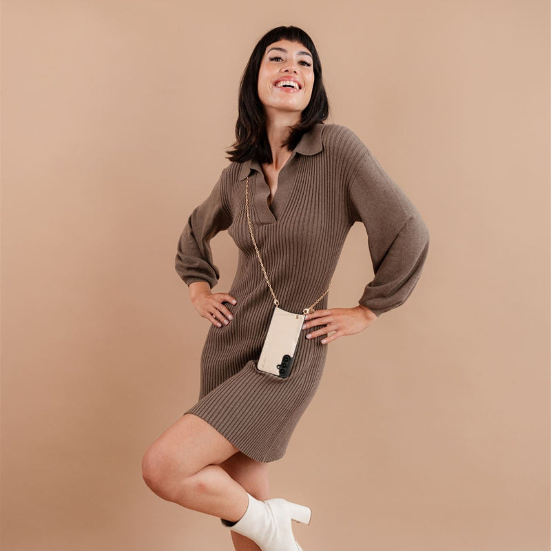 Smiling woman modeling a Samsung Case | Vanilla with cardholder, stylishly paired with a knitted dress.