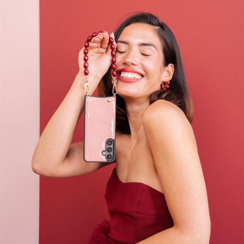 Woman smiling while holding the Samsung Case | Gloss Pink with beads, showcasing its stylish design and cardholder features.