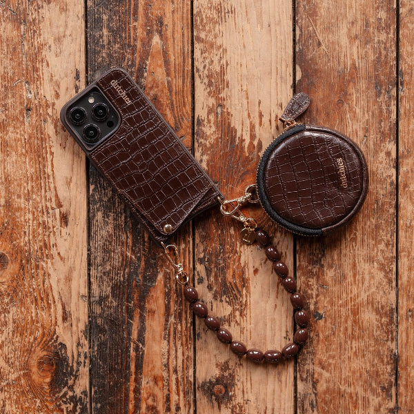 Phone Charm | Beaded | Sia - Dark Brown Beaded Mobile Phone Charm with matching pouch and beads on a wooden background.