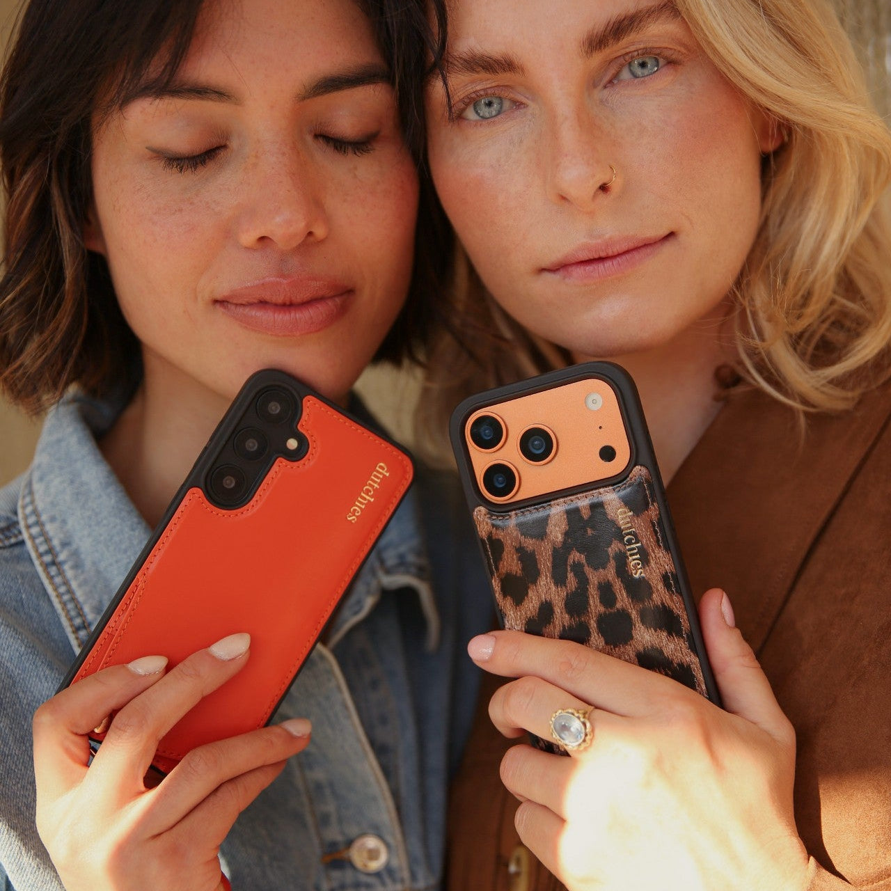 Two women showcasing stylish phone cases, including an iPhone Case | Leopard.